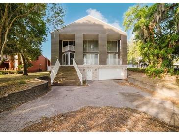 Striking two-story home with an elevated front entrance and a two car garage at 8322 Lake Lucy Dr, Orlando, FL 32818