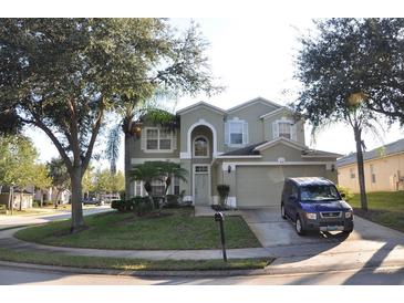 Charming two-story home featuring lush landscaping and an attached two-car garage in a suburban neighborhood at 913 Henley Cir, Davenport, FL 33896