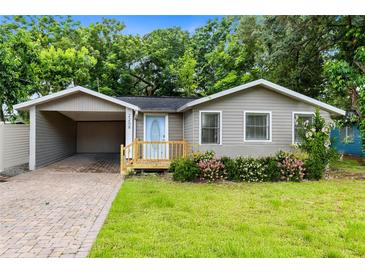 Charming single-story home featuring a carport and well-maintained front yard with fresh landscaping at 2208 Page Ave, Orlando, FL 32806