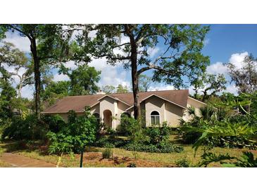 Charming single-story home with a well-manicured lawn and lush landscaping, providing great curb appeal at 398 Pine Tree Rd, Lake Mary, FL 32746