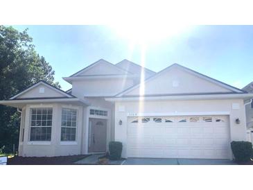 Charming one-story home with a two-car garage and manicured landscaping at 5509 Florence Harbor Dr, Orlando, FL 32829