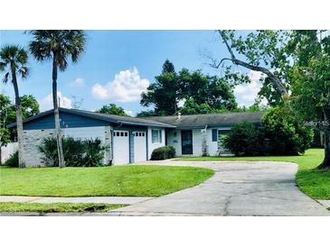 Charming single-story home with a well-maintained lawn and attached two-car garage at 6429 Voltaire Dr, Orlando, FL 32809