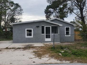 Charming home featuring a stucco exterior, well-maintained yard, and a welcoming entrance at 1303 37Th Nw St, Winter Haven, FL 33881