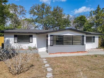 Charming single-story home features a freshly painted exterior, dark shutters, and an inviting front entrance at 1382 Wright St, Daytona Beach, FL 32117