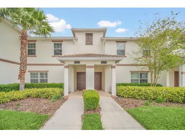 Inviting townhome exterior with manicured landscaping and a well-maintained facade at 1569 Plunker Dr, Davenport, FL 33896