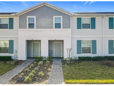 Charming townhome featuring a well-manicured lawn and a welcoming entrance, perfect for easy living at 201 Jetty Way, Davenport, FL 33897