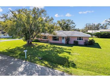 Charming single-story home with a lush lawn and mature tree in a quiet neighborhood at 522 Wisconsin Ave, St Cloud, FL 34769