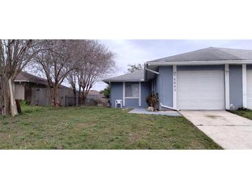 Charming blue home featuring a single car garage and an easy to maintain front yard at 5843 Willow Leaf Ct, Orlando, FL 32807