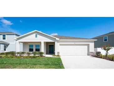 Charming single-story home featuring a manicured lawn, two-car garage, and covered entryway at 64 Citrine Loop, Kissimmee, FL 34758