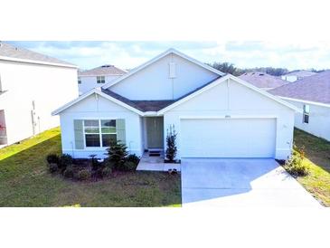 Charming one-story home featuring a two-car garage, well-manicured lawn, and a welcoming front entrance at 6910 Se 111Th Pl, Belleview, FL 34420