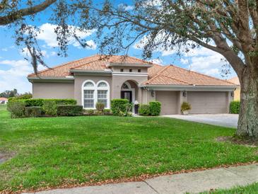 Beautiful single-story home showcasing a tile roof, manicured landscaping, and a two-car garage at 11327 Ledgement Ln, Windermere, FL 34786