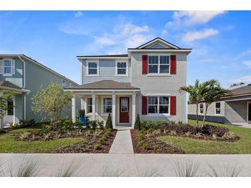 Charming two-story home with red shutters and inviting front porch at 12471 Shipwatch St, Orlando, FL 32832