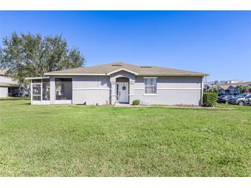 Charming single-story home featuring a well-manicured lawn and a welcoming front entrance at 13101 Summerton Dr, Orlando, FL 32824