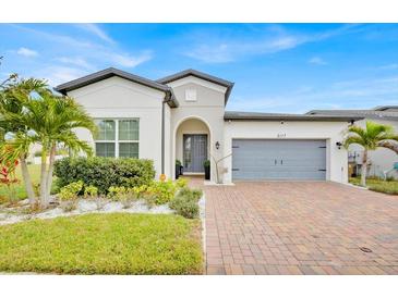 Beautiful single-story home with a well-manicured lawn, brick driveway and attached two car garage at 2117 Trani Ter, St Cloud, FL 34771