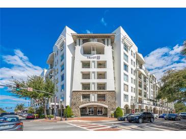 Beautiful exterior of the condo building featuring balconies and a stone archway entrance at 2305 Edgewater Dr # 1701, Orlando, FL 32804