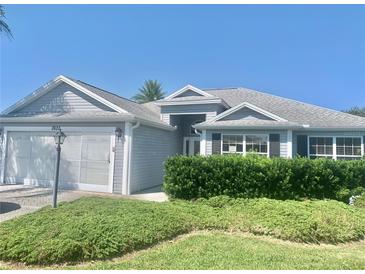 Charming single-story home with well-manicured landscaping at 2628 Caribe Dr, The Villages, FL 32162