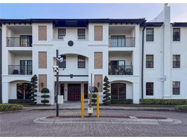 Attractive exterior of a multi-story condo building with balconies, dark trim, and well-maintained landscaping at 5550 E Michigan St # 3309, Orlando, FL 32822