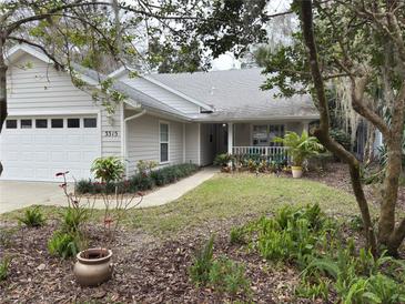 Charming single-story home featuring a well-manicured front yard and attached two-car garage in quiet neighborhood at 3315 Newbliss Cir, Ormond Beach, FL 32174