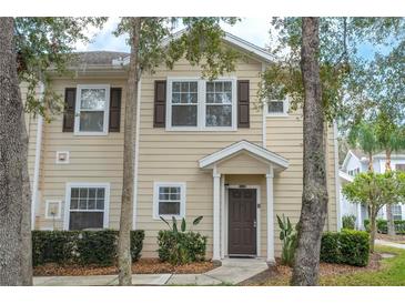 Charming two-story townhome with neutral siding, brown shutters and door, and well-maintained landscaping at 5356 Diplomat Ct # 105, Kissimmee, FL 34746