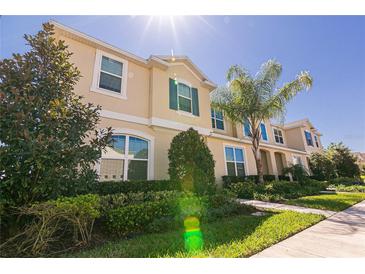 Charming two-story home featuring lush landscaping and a well-manicured front yard at 1507 Carey Palm Cir, Kissimmee, FL 34747