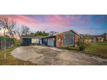Charming single-story home with a mix of brick and siding under a colorful sky at 38934 Sulen Rd, Lady Lake, FL 32159