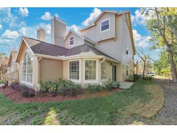 Inviting home featuring mature landscaping, neutral tones and an abundance of windows at 615 Richland Ct # 61, Altamonte Springs, FL 32714