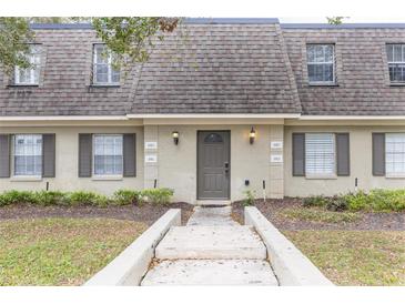 Inviting front entrance featuring a concrete walkway, well-maintained landscaping, and a neutral-colored facade with decorative lighting at 1913 Woodcrest Dr # B, Winter Park, FL 32792