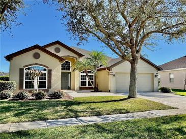 Charming single-Gathering home with a well-manicured lawn, two-car garage, and a welcoming front entrance at 472 Huntington Pines Dr, Ocoee, FL 34761