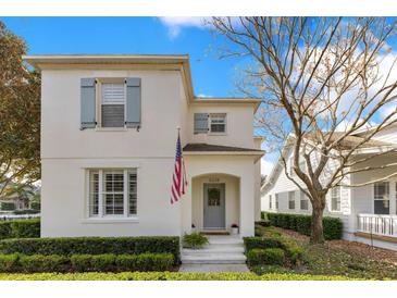 Charming two-story home with blue shutters and an inviting covered entry and a well manicured front lawn at 5238 Baskin St, Orlando, FL 32814