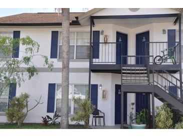 Multi-Gathering home with blue doors and shutters with black metal staircases and green plants at 3651 N Goldenrod Rd # 210, Winter Park, FL 32792