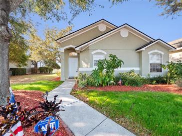 Charming single-story home featuring manicured landscaping and a welcoming walkway leading to the front door at 3967 Campfire Way, Casselberry, FL 32707