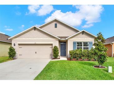 Charming single-story home featuring a two-car garage and a well-manicured lawn at 432 Tallow Wood Cir, Debary, FL 32713