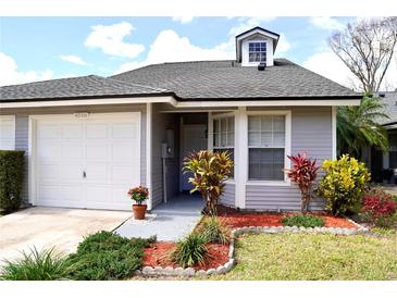 Charming single-story home with a one car garage, well-kept lawn, and colorful landscaping at 4516 Summergrove Ave, Orlando, FL 32812