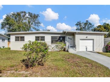 Charming single-story home showcasing a well-maintained yard and attached garage at 4521 Jim Glenn Dr, Orlando, FL 32808