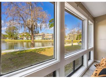 Stunning water view from large windows, creating a bright and airy atmosphere with natural light at 5842 Peregrine Ave # C01, Orlando, FL 32819