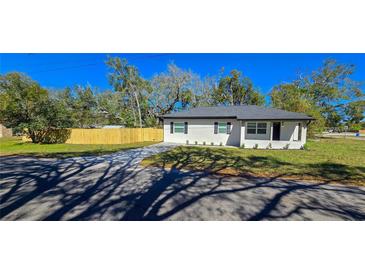 Charming single-story home boasts fresh exterior paint and a newly installed wooden fence, enhancing curb appeal at 1322 Maryland Ave, St Cloud, FL 34769