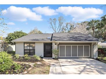 Charming single-story home with a well-manicured front yard and attached two-car garage at 1412 Borg Ln, Winter Springs, FL 32708