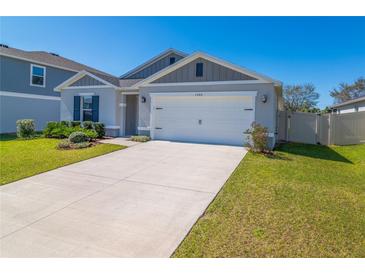 Charming single-story home showcasing a two-car garage, tidy landscaping, and a well-maintained lawn at 1546 Park Leah Cir, Apopka, FL 32712