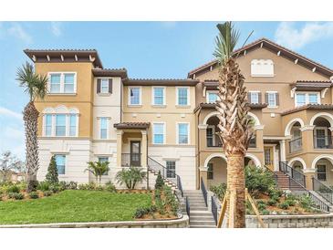 Elegant multi-story townhome with lush landscaping, beautiful architecture, and inviting front entrance at 2041 Lobelia Dr, Lake Mary, FL 32746