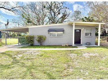 Charming single-story home featuring a covered carport, tidy landscaping and neutral color palette at 430 Pennsylvania Ave, Winter Garden, FL 34787