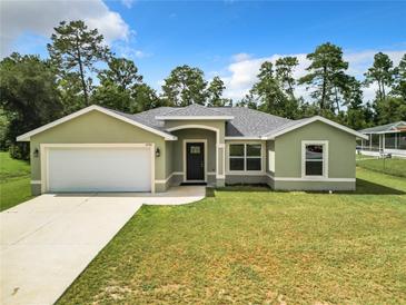 Charming single-story home features manicured lawn and attached two-car garage at 4790 Sw 166Th Loop, Ocala, FL 34473