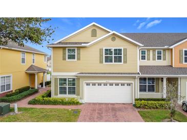 Inviting two-story home featuring a brick driveway, attached two car garage and beautiful landscaping at 4820 Battaglia Blvd, St Cloud, FL 34769