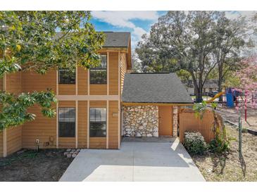 Charming two-story townhome with wood siding, stone accents, and a well-kept front yard at 486 Abba St, Altamonte Springs, FL 32714