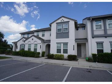 A two-story townhome featuring a well-maintained lawn and a convenient parking area at 510 Captiva Dr, Davenport, FL 33896