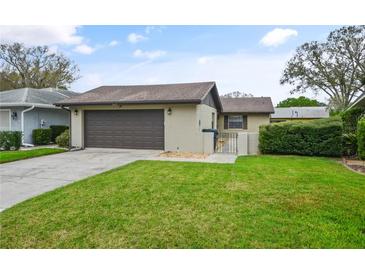 Charming home with a well-maintained lawn, inviting curb appeal, and a two-car garage at 620 Wexford Ct, Winter Haven, FL 33884