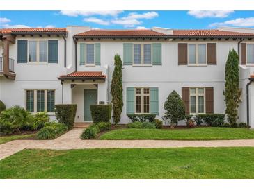 Charming townhome featuring a red tile roof, colorful shutters, and manicured landscaping at 8742 European Fan Palm Aly, Winter Garden, FL 34787