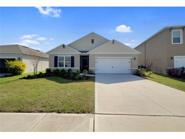 Charming single-story home featuring a well-maintained lawn, a two car garage and stylish exterior details at 944 Brooklet Dr, Davenport, FL 33837