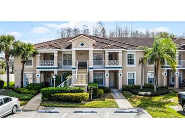 Well-maintained condo with a tile roof, manicured landscaping, and reserved parking at 13801 Timberland Dr # 202, Orlando, FL 32824