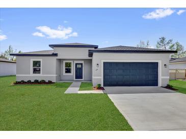 Beautiful one story home with a two car garage and landscaped yard at 166 Marion Oaks Ln, Ocala, FL 34473