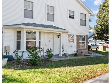 Charming two-story exterior with a well-maintained lawn, an inviting front door, and a bay window at 2413 Tack Room Ln # 2, Orlando, FL 32812